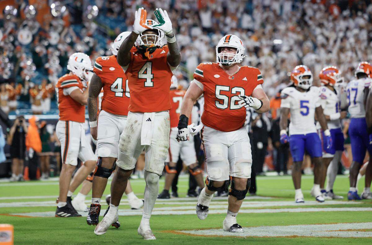 Miami Hurricanes running back Mark Fletcher Jr. (4) flashes the U after scoring in the second half of their NCAA football game against the Florida Gators at Hard Rock Stadium in Miami Gardens, Florida, on Saturday, September 20, 2025.