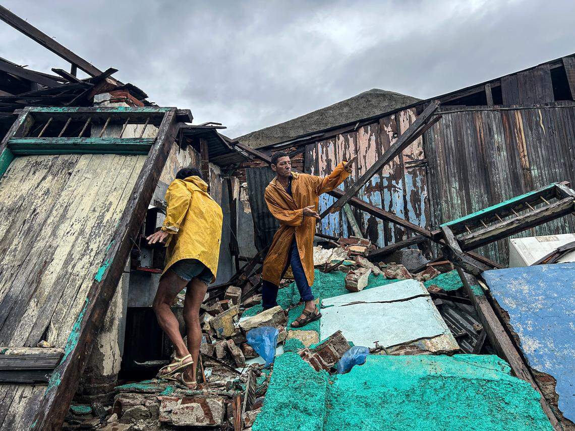 A family salvages belongings from the rubble of their home after it collapsed during Hurricane Melissa's passage through Santiago de Cuba, Cuba, on October 29, 2025.