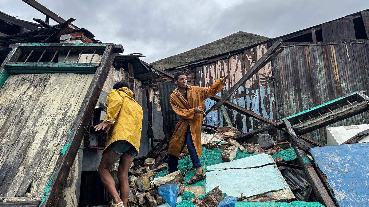 A family salvages belongings from the rubble of their home after it collapsed during Hurricane Melissa's passage through Santiago de Cuba, Cuba, on October 29, 2025.