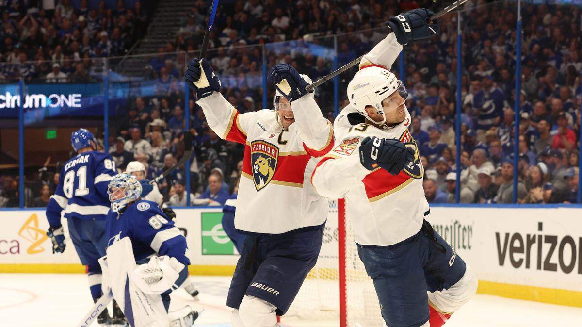 Apr 25, 2024; Tampa, Florida, USA; Florida Panthers center Sam Reinhart (13) is congratulated by center Aleksander Barkov (16) after scoring against the Tampa Bay Lightning during the second period in game three of the first round of the 2024 Stanley Cup Playoffs at Amalie Arena.