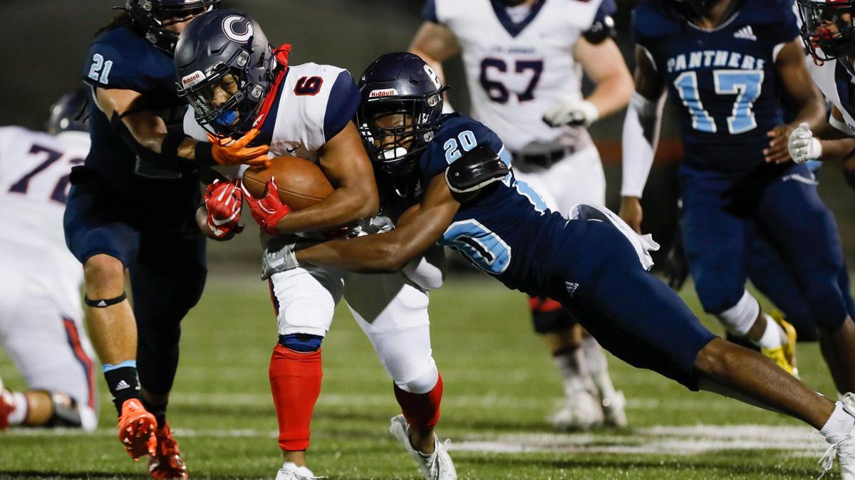 Columbus Explorers running back Denim Edwards (6) runs with the football against Palmetto cornerback Omari Winkfield (20) during the second quarter of the Region 4-Class 8A high school football championship game at Harris Field Park in Homestead, Florida, on Friday, November 26, 2021.