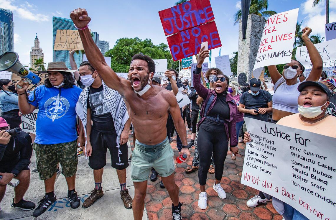 Johnny, at center, screams as he joins fellow demonstrators during George Floyd protest in downtown Miami on Saturday, May 30, 2020.