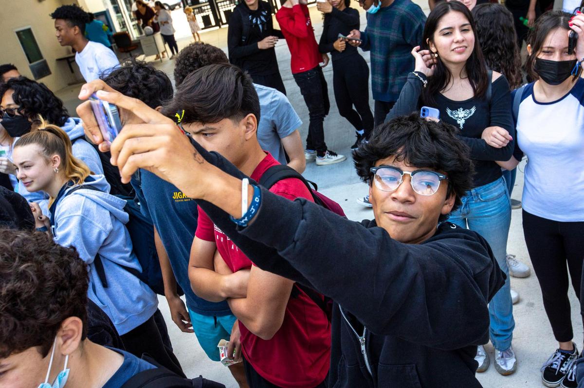 Miami Palmetto High School sophomore Joseph Murillo, 15, records video of the pep squad performing during a lunch pep rally to honor alumnus and now Supreme Court Justice Ketanji Brown Jackson, on Friday, April 8, 2022.