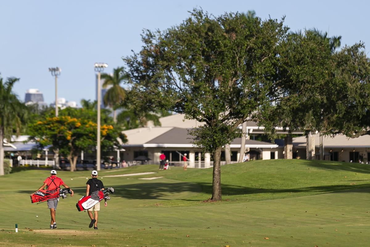 Golfers walk off the International Links Melreese Country Club in Miami on Tuesday.