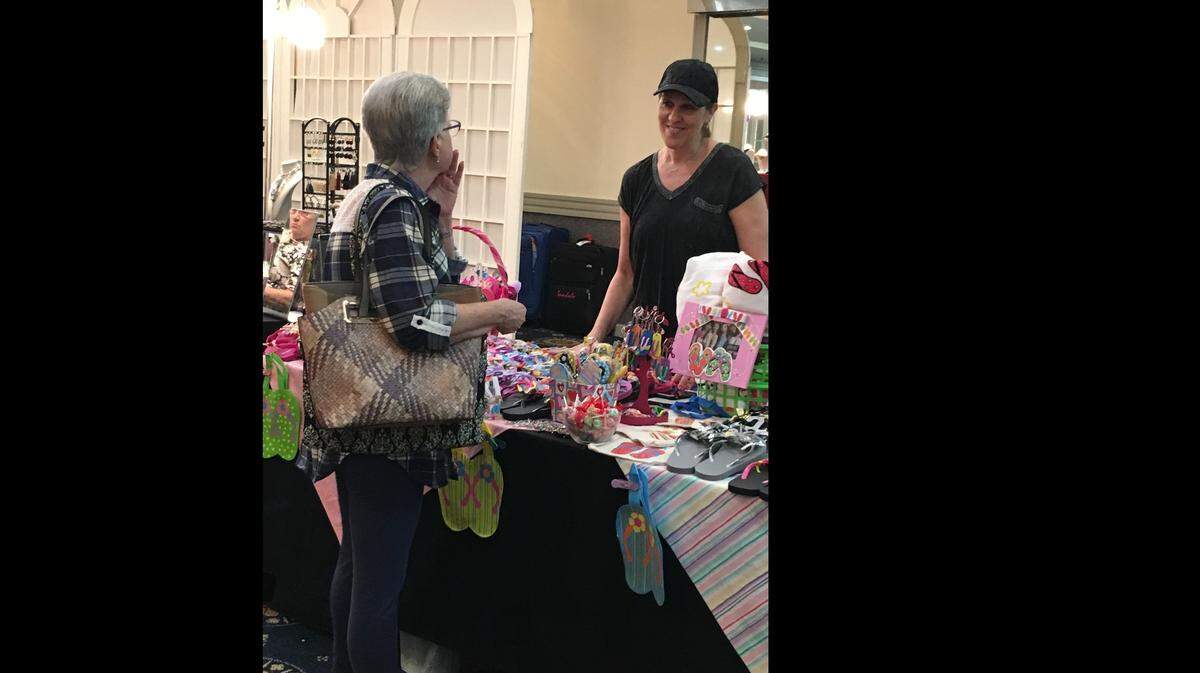 A shopper talks with a vendor at the 2018 Bet Shira Sisterhood Annual Holiday Bazaar.