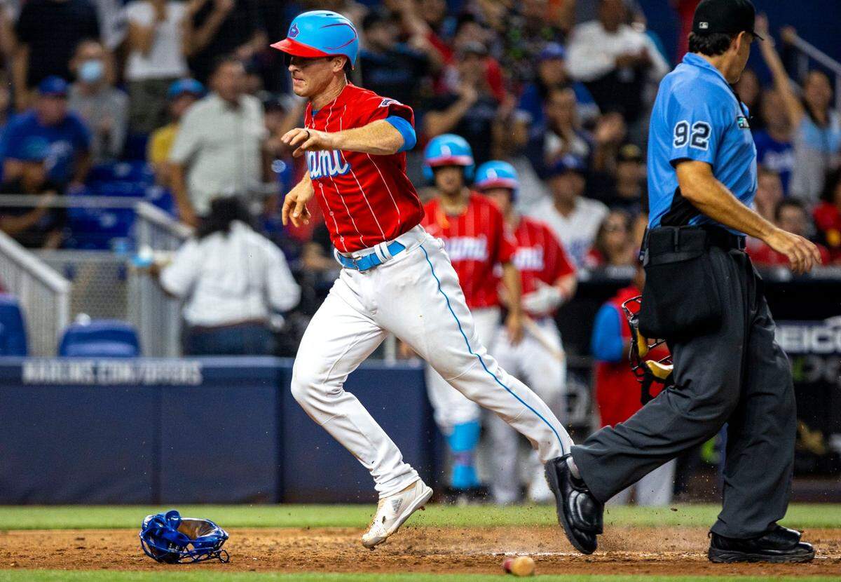 Miami Marlins base runner Joey Wendle crosses home plate to score during the sixth inning of an MLB game against the Los Angeles Dodgers at loanDepot park in the Little Havana neighborhood of Miami, Florida, on Saturday, August 27, 2022.