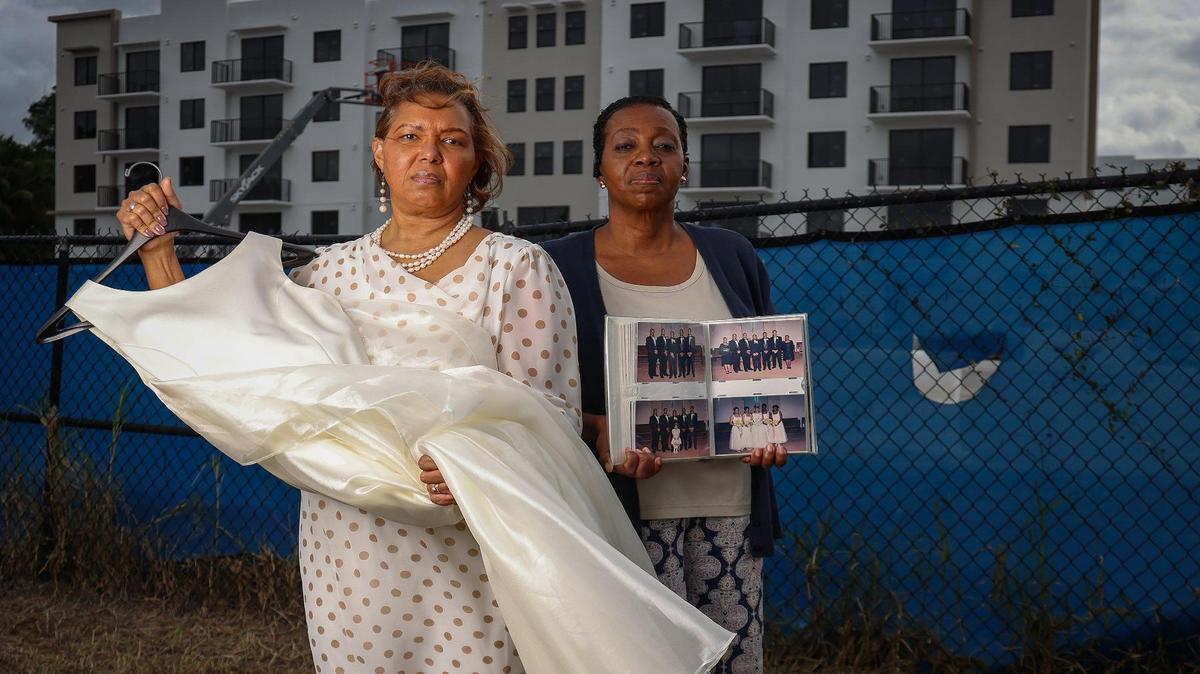 Annette Kidd, left, holds the dress she wore for her 15-year wedding vow renewal that was held at her home church of over 25 years, Evangel Church International. Naomi Francis-Roberts, right, holds her wedding album. The Assemblies of God church sold its eight-acre property to developers in and rebranded to Collab.Church in 2022.