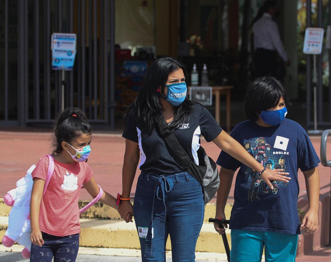 United Teachers of Dade President Karla Hernandez-Mats, center, cautiously crosses the street with her daughter, Naomi, 7, left, and son, Benjamin Mats,12, right, after he received the COVID-19 vaccination upon turning 12 at the pop-up vaccination clinic. On Tuesday, Sept. 7, 2021, the United Teachers of Dade, the teachers’ union for Miami-Dade public schools, held a pop-up vaccine clinic at Lillie C Evans K-8, 1895 NW 75th St., to raise awareness of the importance of vaccines. Thirteen employees with Miami-Dade Public Schools have died from COVID since the school year began on Aug. 23 and none were vaccinated.