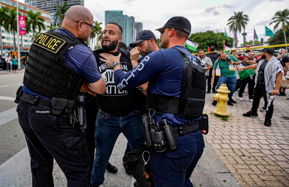 Miami Police detain a pro-Palestinian protester during a rally in support of Palestinians in Gaza during the conflict between Israel and Hamas along Biscayne Blvd, Bayfront Park in Miami on Friday, October 13, 2023.