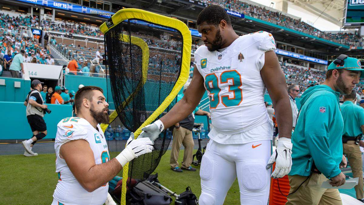 Miami Dolphins defensive tackles Zach Sieler (#92) and Calais Campbell (#93) chat before the team’s NFL game against the New York Jets at Hard Rock Stadium on Sunday, Dec. 8, 2024, in Miami Gardens, Florida.