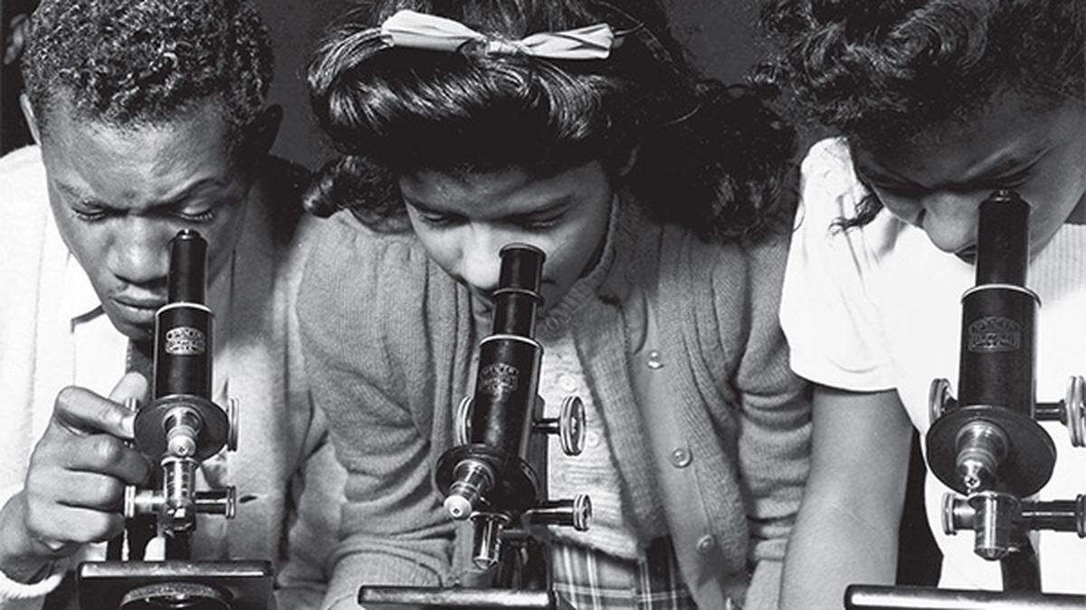 Bethune-Cookman College students peer through microscopes in 1943.