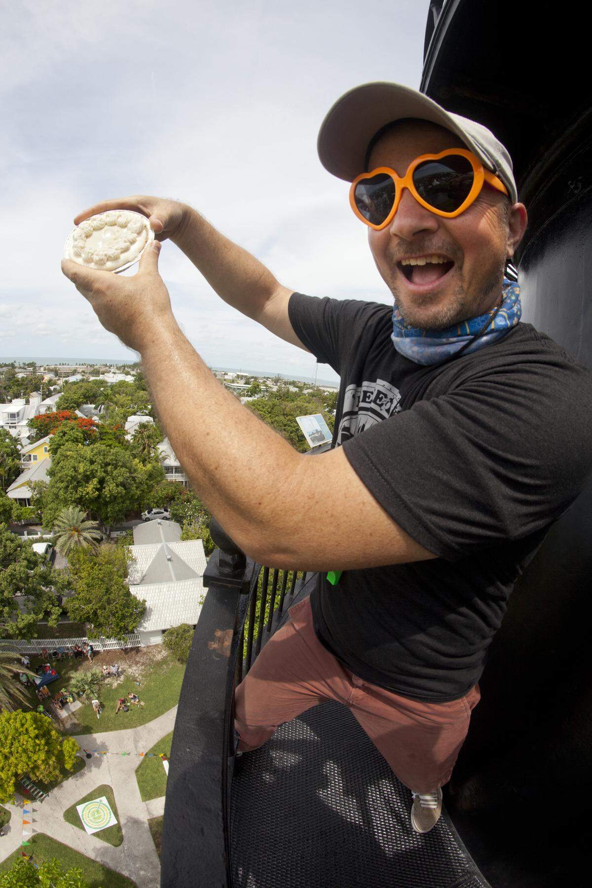 Key Lime Festival co-producer Marky Pierson demonstrates the size of the pie and the distance of the drop that contestants must factor for when creating a device or container to protect the island’s trade-mark sweet treat for the Saturday, July 6, Key Lime Pie Drop contest at the Key West Lighthouse.