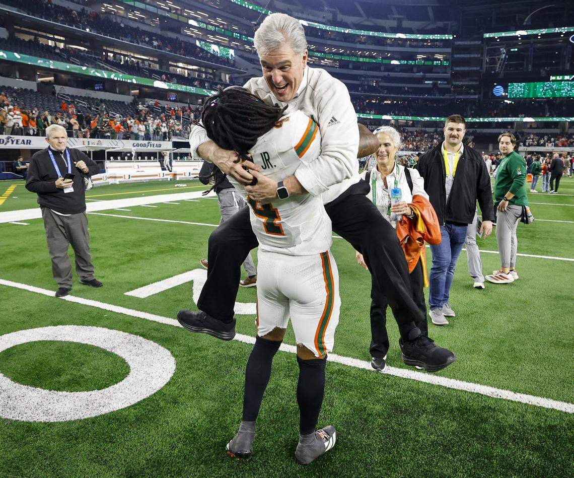 Miami Hurricanes Vice President / Director of Athletics Dan Radakovich leaps into the arms of Miami Hurricanes running back Mark Fletcher Jr. (4) after the Canes defeat against the Ohio State Buckeyes for the College Football Playoff quarterfinal game in the Cotton Bowl at AT&T Stadium in Arlington, Texas on Thursday, January 1, 2026.