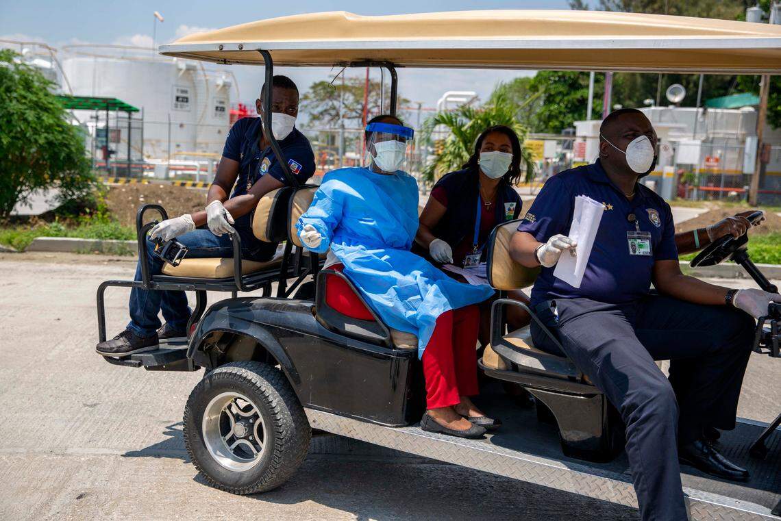 Health ministry workers arrive to check on a group of Haitians who were deported from the United States, at a hotel where they will be quarantined as a measure against the spread of the new coronavirus, in Tabarre, Haiti, Thursday, April 23, 2020.