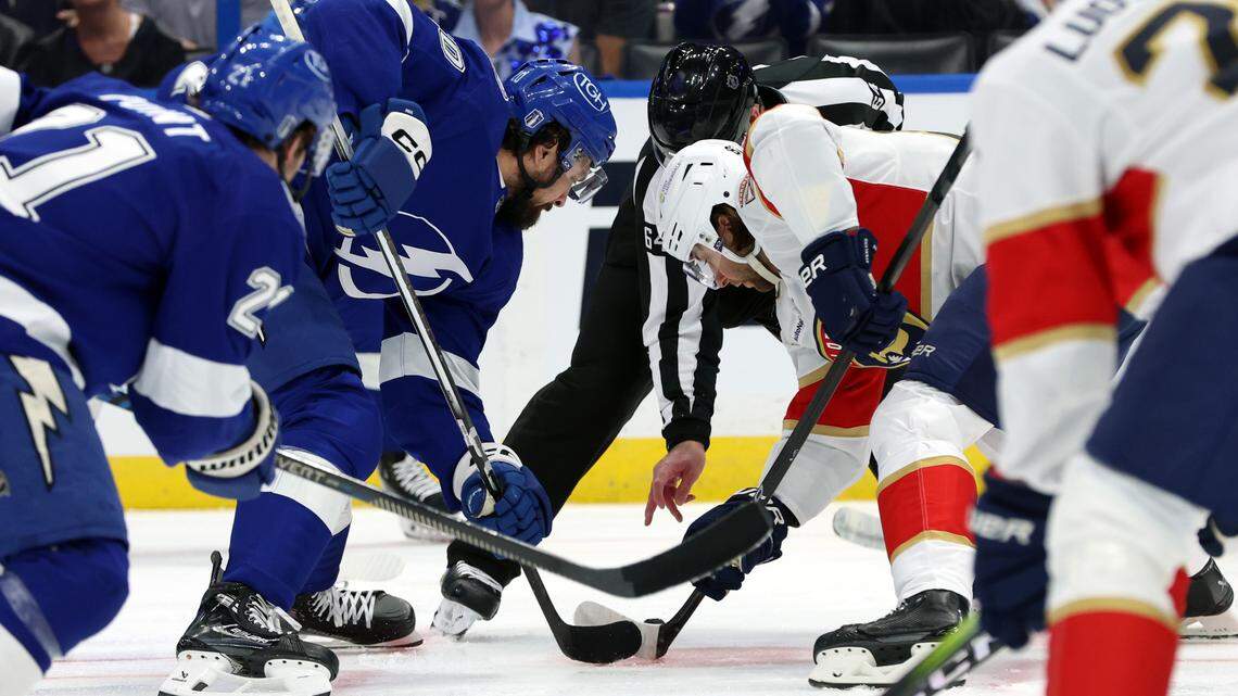 Apr 27, 2024; Tampa, Florida, USA; Tampa Bay Lightning left wing Nicholas Paul (20) and Florida Panthers center Kevin Stenlund (82) face off during the first period in game four of the first round of the 2024 Stanley Cup Playoffs at Amalie Arena.