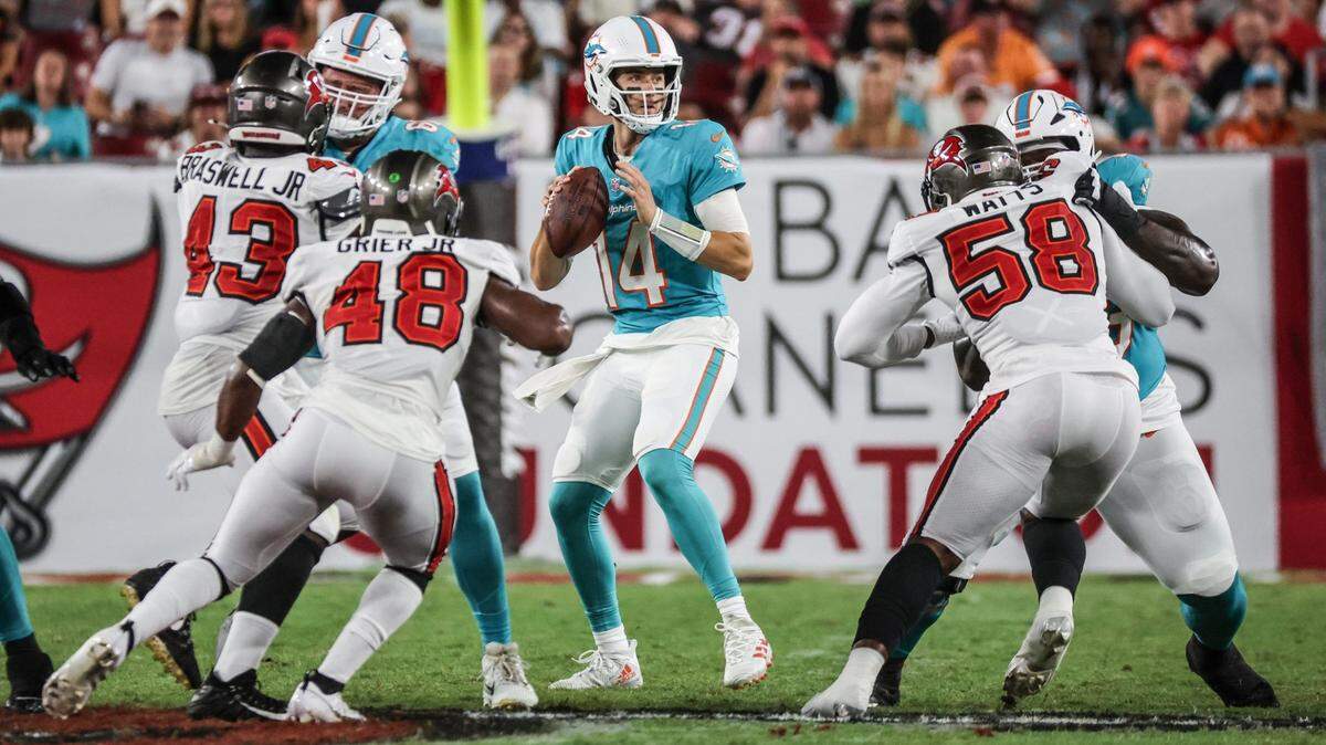 Miami Dolphins quarterback Mike White (14) sets up to pass in the game against the Tampa Bay Buccaneers in the first half at Raymond James Stadium in Tampa, Florida on Friday, August 23, 2024.