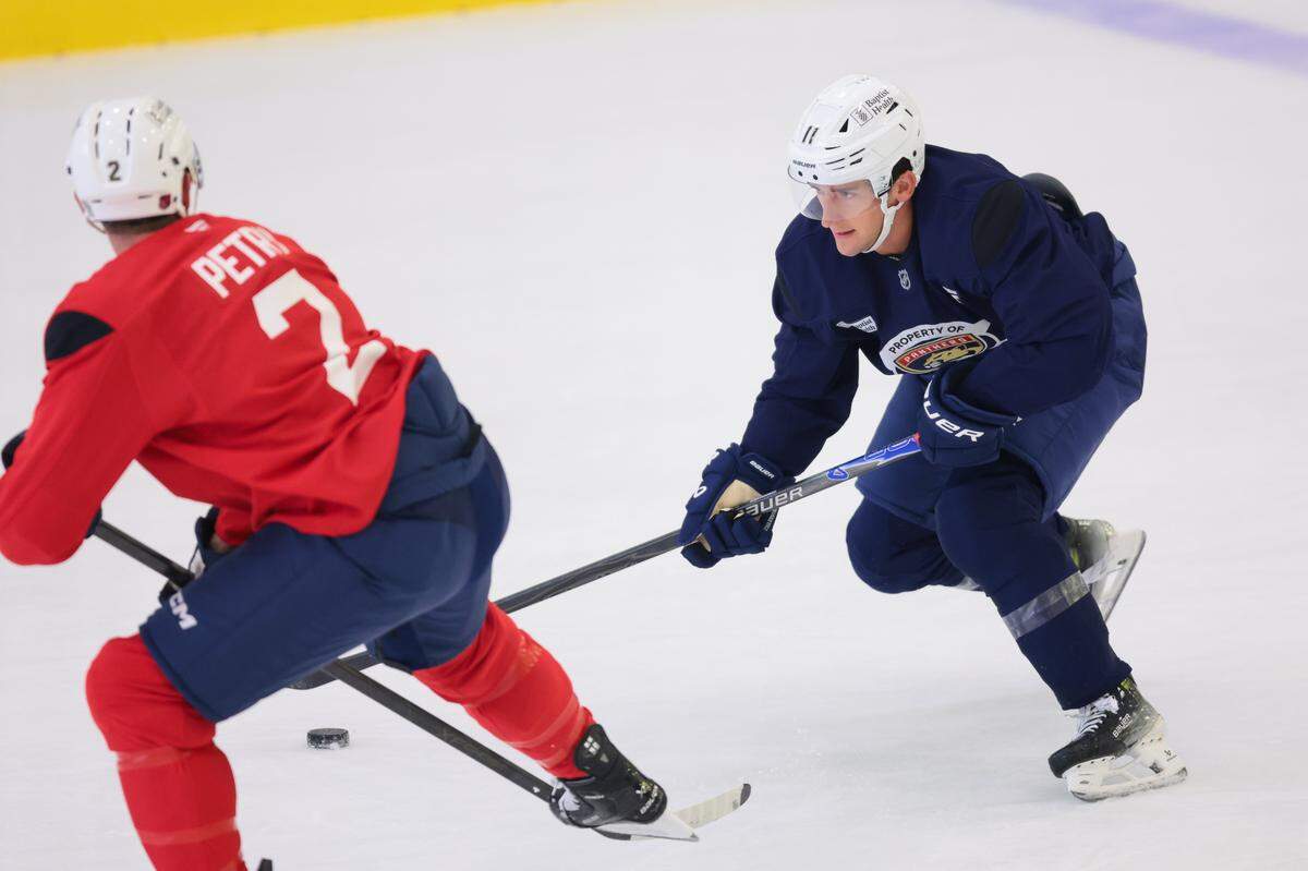 Florida Panthers right wing Mackie Samoskevich (11) moves the puck against defenseman Jeff Petry (2) during practice at Baptist Health IcePlex in Fort Lauderdale, Florida, Sunday, September 28, 2025.