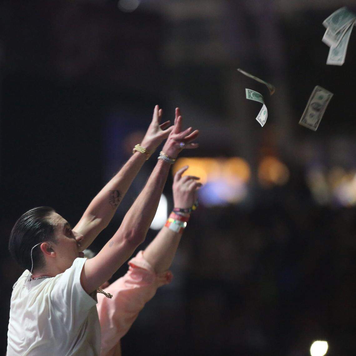 Rapper G-Eazy throws money into the crowd after his performance on the second day of Ultra in 2018.