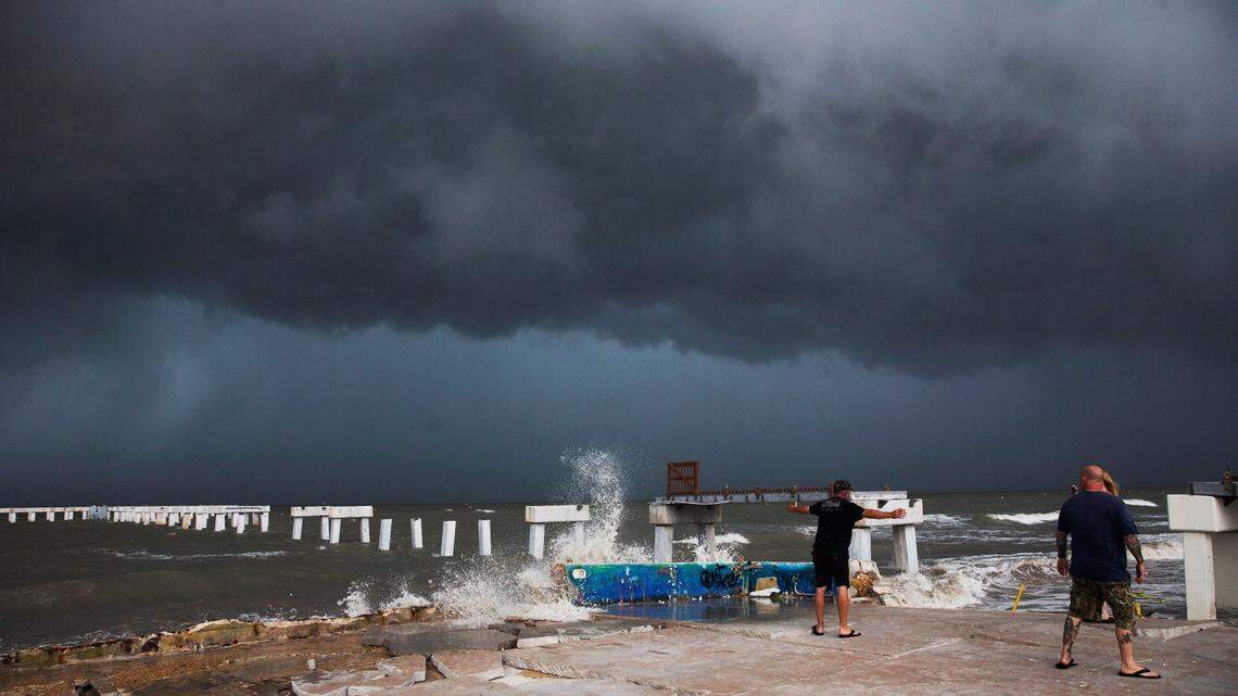 Beachgoers check out the surf as Hurricane Idalia approaches Florida at Times Square on Fort Myers Beach on Tuesday, Aug. 29, 2023.