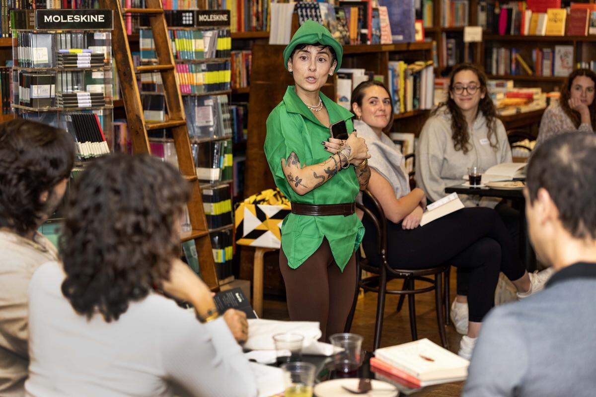 Host Alyssa Expósito speaks to guests during The (Silent) Reading Party at Books & Books on Thursday, October 23, 2025, in Coral Gables, Fla.