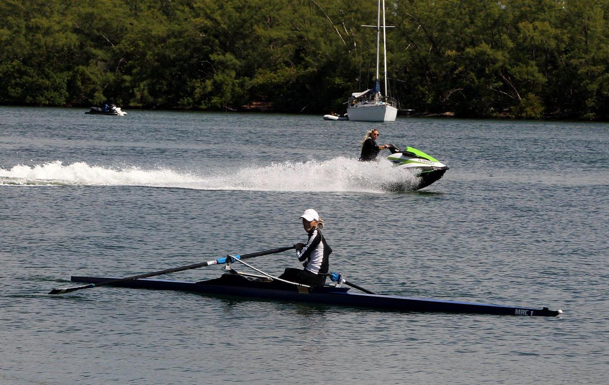 Rower Sue Kern slows down as a speeding water bike passes. A huge increase in water bike and powerboat traffic during the coronavirus pandemic has created a chaotic and dangerous situation at the Miami Marine Stadium basin on Virginia Key.