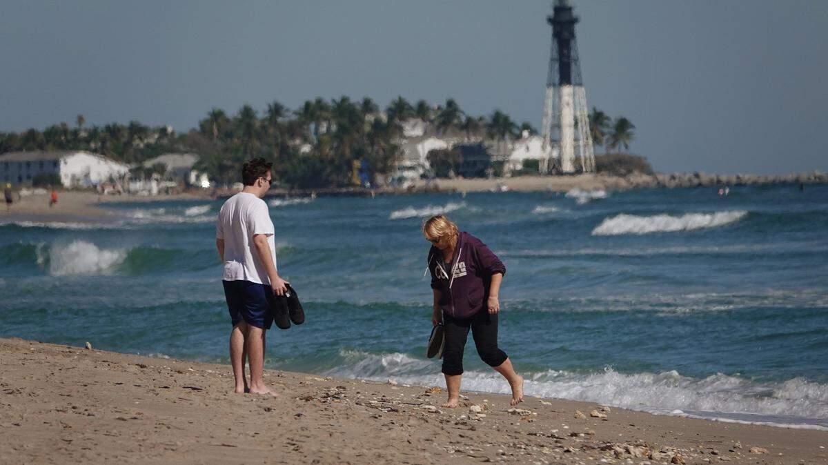 Debbie Trendle of Pompano Beach looks for shells along with her son Raymond who is visiting from Baltimore, Tuesday, Jan. 29, 2109, in Pompano Beach. The recent storms and onshore winds have washed an abundance of shells onto South Florida beaches.