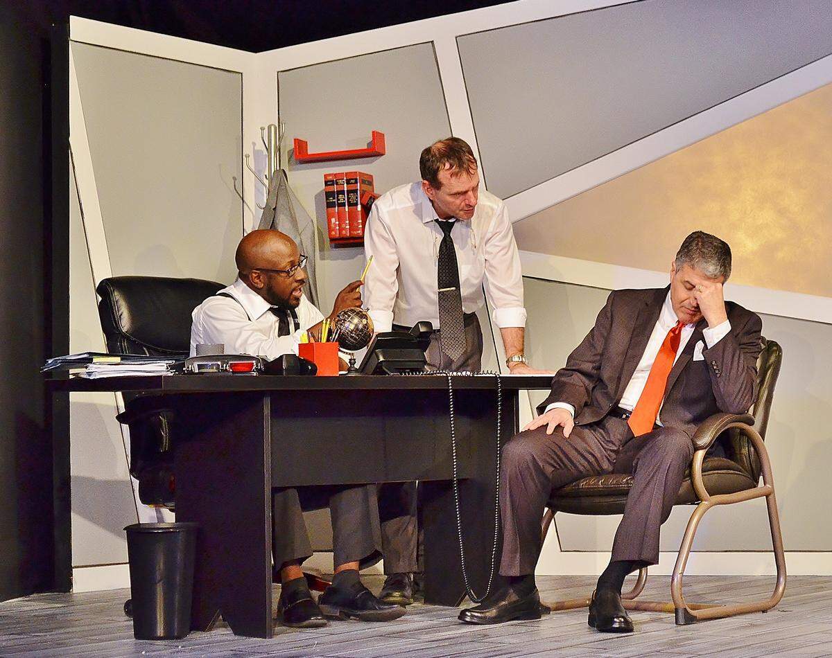 Keith R. Oliver and Christopher Dreeson caution Brian McCormack against speaking to the media in Main Street Players’ ‘Race.’