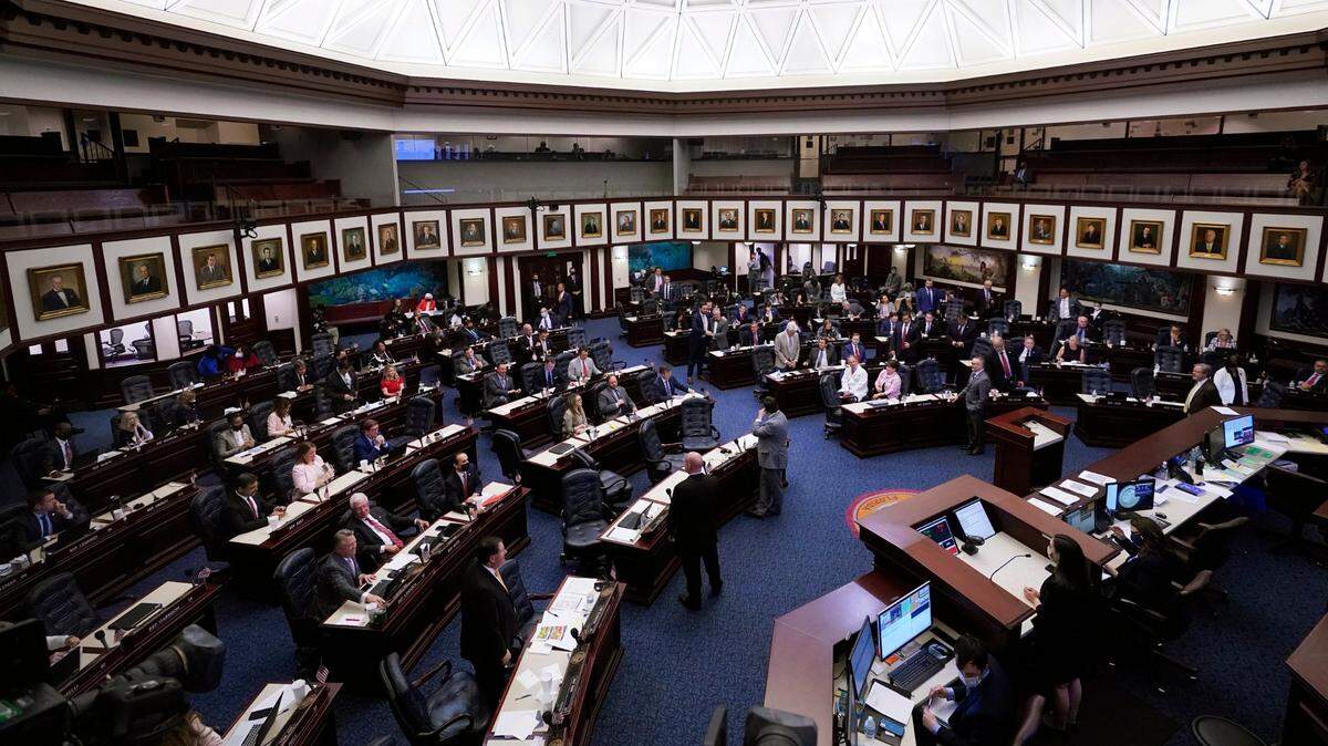 Members of the Florida House of Representatives work during a legislative session, Friday, April 30, 2021, at the Capitol in Tallahassee.