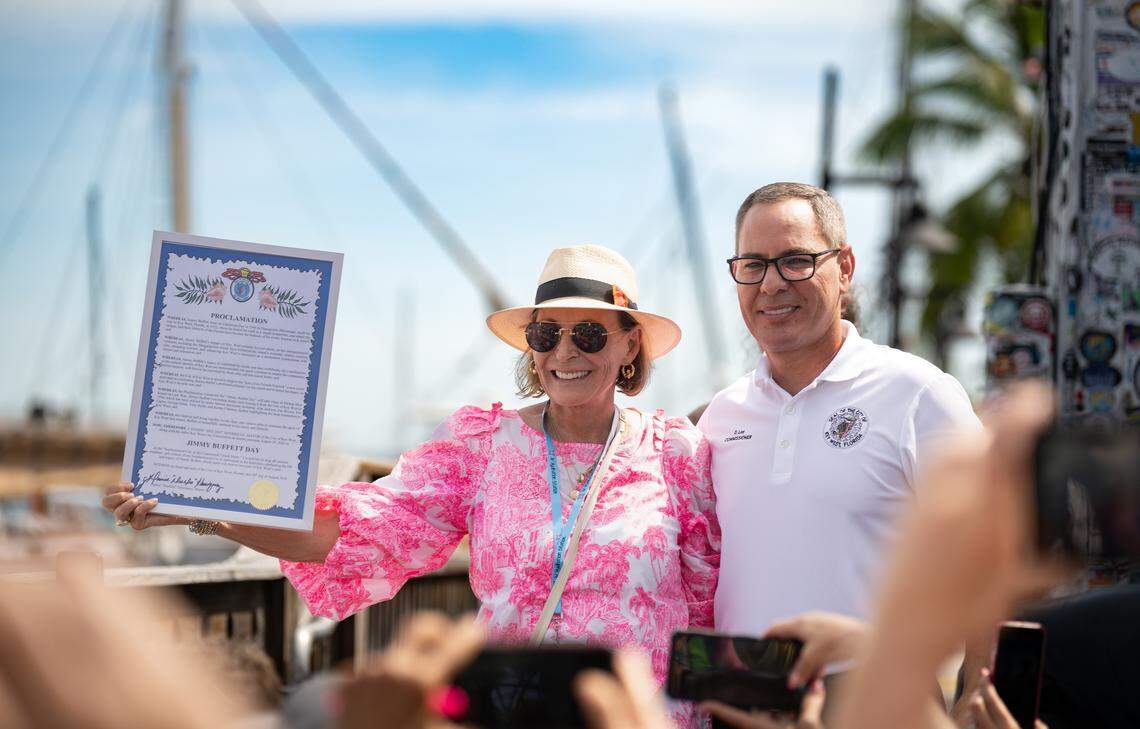 Restaurateur and author Lucy Buffett, sister of the late Jimmy Buffett, accepts a proclamation designating Jimmy Buffett Day from Key West City Commissioner Donie Lee on Friday, Aug. 29, 2025, in Key West, Fla. Held outside the singer-songwriter’s Shrimpboat Sound recording studio, the proclamation ceremony kicked off the four-day Just a Few Friends festivities honoring Buffett’s legacy on the island that inspired his signature sound.