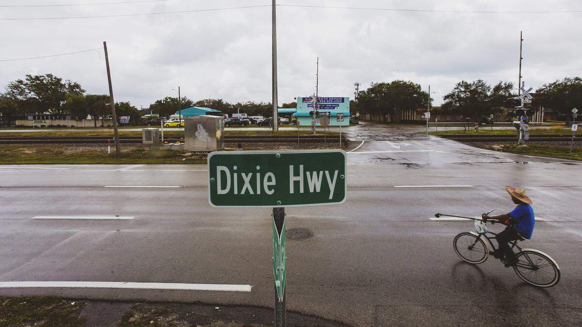 A bicyclist turns onto Dixie Highway in Hollywood, Florida, Jan. 17, 2020. Leaders in some South Florida communities are debating whether to change the name of Dixie Highway, which some say glorifies the nation’s racist history.