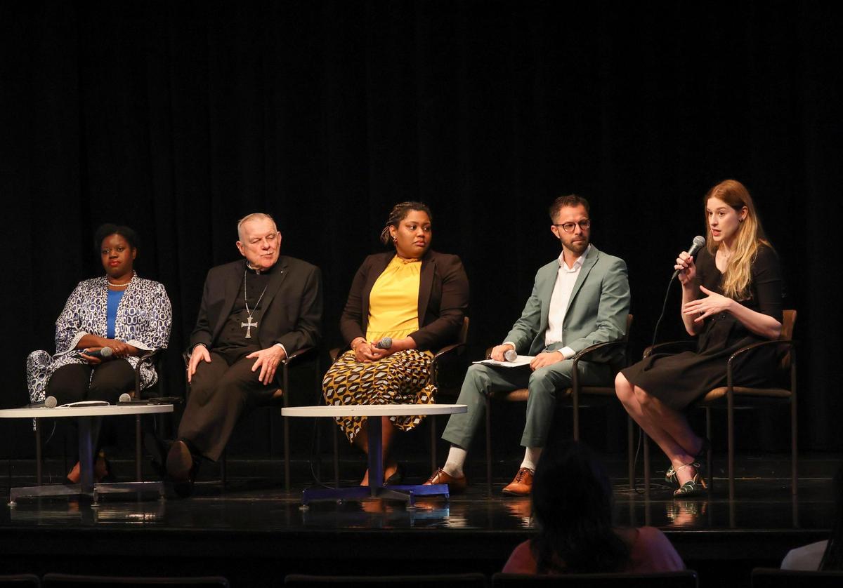 Johanna Cervone, right, chief of staff to Miami-Dade County Mayor Daniella Levine-Cava, speaks to attendees and other panelists about immigration on Thursday, Feb. 23, 2023, at Miami Dade College Wolfson Campus Auditorium.
