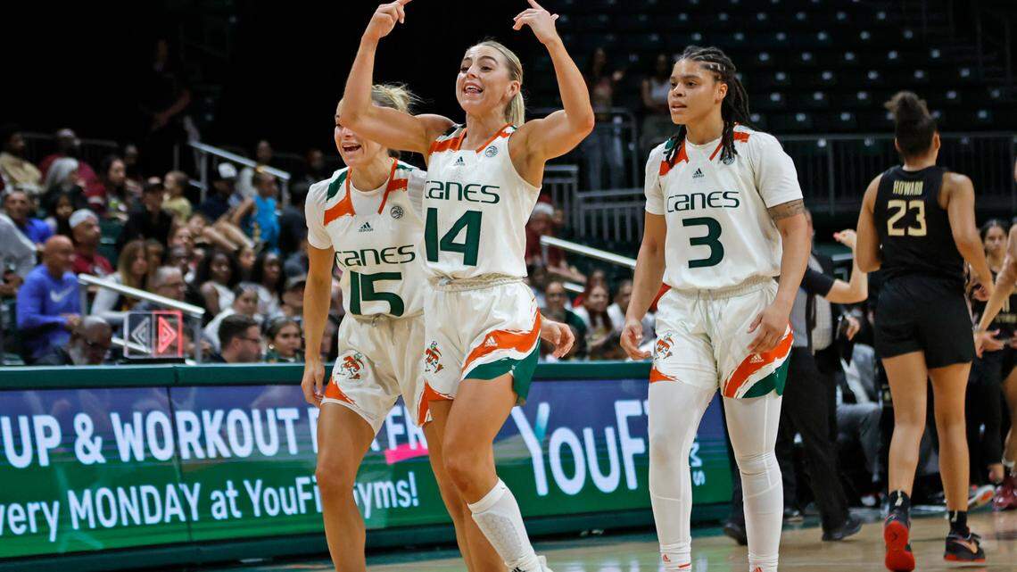 Miami Hurricanes guard Haley Cavinder (14) celebrates on the court with guard Hanna Cavinder (15) and forward Destiny Harden (3) as the Canes lead against the Florida State Seminoles in the fourth quarter at the Watsco Center in Coral Gables, Fl. on Thursday, February 9, 2023.
