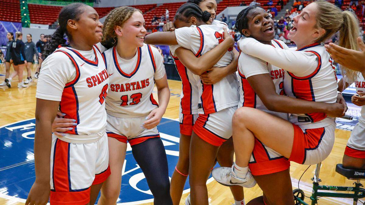 Miami Country Day’s Arianna Robinson (0), Jalynn Belton (13), Kennedy Deal (21) and Josephine Ifergan (1), at front left to right, celebrate with teammates on the court after defeating Providence School for the FHSAA Class 2A Girls High School Basketball State Championship at the RP Funding Center in Lakeland, Florida on Saturday, March 1, 2025. 

