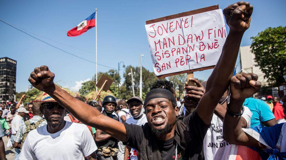Demonstrators march in Port-au-Prince on February 14, 2021, to protest against the government of President Jovenel Moise. - Several thousand people demonstrated on February 14, 2021 to denounce a new dictatorship in Haiti and the international community’s support for President Jovenel Moise. The protesters were accusing Moise of illegally extending his term. He says it lasts until February 2022 -- but the opposition argues it should have ended last weekend, in a standoff over disputed elections.