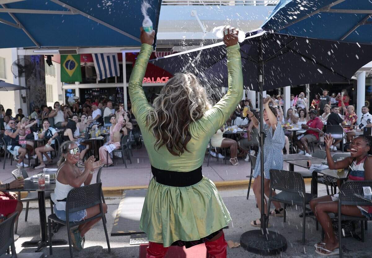 “Missy Meyake Lepaige,” center, showers herself with bottled water as she engages the crowd with a dance and lip-sync performance at the Palace on Sunday, June 28, 2026, in Miami Beach, Fla.The Palace, an LGBTQ + friendly bar and restaurant, is known for its high-energy weekend drag brunches, where performers entertain guests with choreographed dances, lip-syncs and audience interaction. The scene was photographed on Sunday, June 28, 2026, in Miami Beach, Fla.