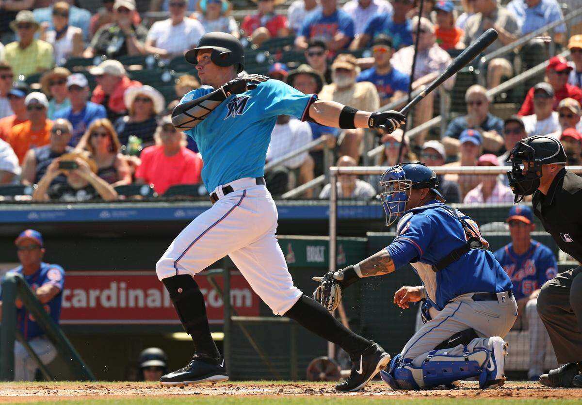 Miami Marlins right fielder Peter O’Brien (45) bats during the first inning of a Major League Baseball spring training game against the New York Mets at the Roger Dean Chevrolet Stadium on Tuesday, March 12, 2019 in Jupiter, FL.