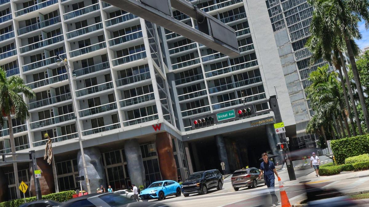 Commuters, pedestrians, and residents navigate the intersection in front of the Icon Brickell Residence where Dominic Ferrell,17, was stabbed to death over the weekend by a stranger on Wednesday, June 11, 2025, in Miami, Florida.