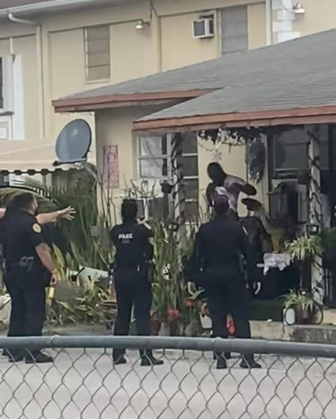 Miami police officers confront a man armed with either a knife or screwdriver on the front porch of a house in Liberty City Thursday, March 7, 2024. At least one officer opened fire on the man moments later.