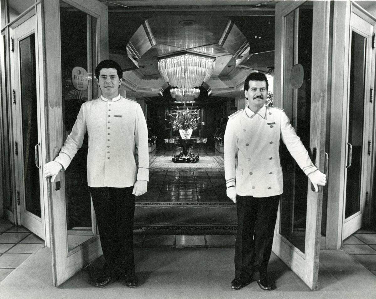 Alberto Avile and Ezequiel Rodriguez hold open the front doors of the $30 million Grand Bay Hotel in Coconut Grove in this file photo from Jan. 9, 1986. On the 13th floor, Régine’s was the pre-eminent discotheque in Miami in the 1980s, attracting the world’s biggest stars and the South Florida elite.