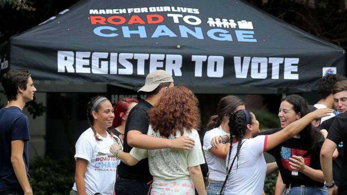 Students and supporters from the March for Our Lives movement gather at voter-registration table.