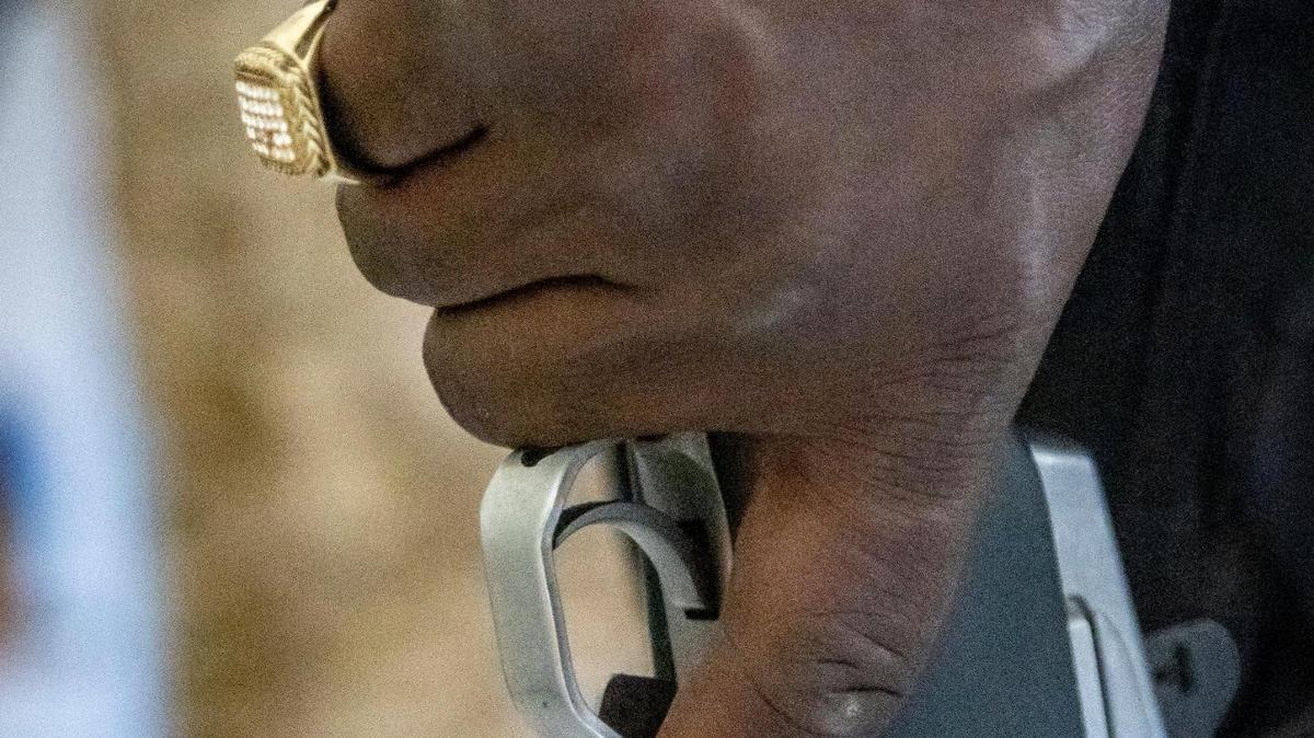 A Haitian policeman holds his gun while on patrol in Port-au-Prince, Haiti on June 23, 2022. Police say they often lack bullets and body armor to confront gangs.