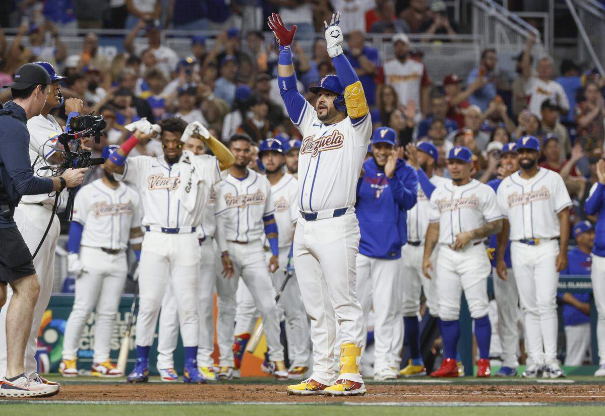 Venezuela third baseman Eugenio Suárez (7) celebrates at homeplate after a homer on a fly ball to left field, bringing in catcher Salvador Perez (13) to score during the first inning of the World Baseball Classic against Israel at loanDepot park in Miami, Florida, on Saturday, March 7, 2026. 