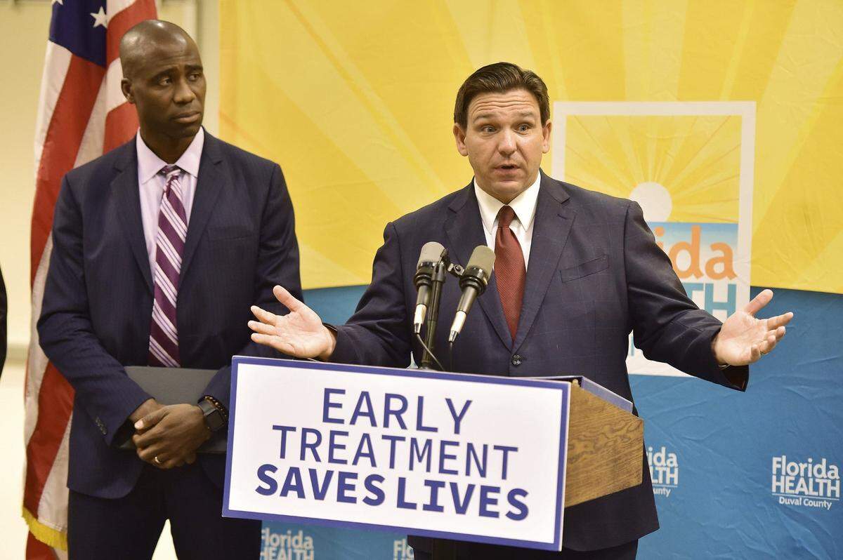 Florida Gov. Ron DeSantis, seen with Dr. Joseph Ladapo, Florida’s surgeon general, addresses a question during a 2022 Jacksonville news conference to discuss COVID-19 testing policy and monoclonal antibody treatment availability.