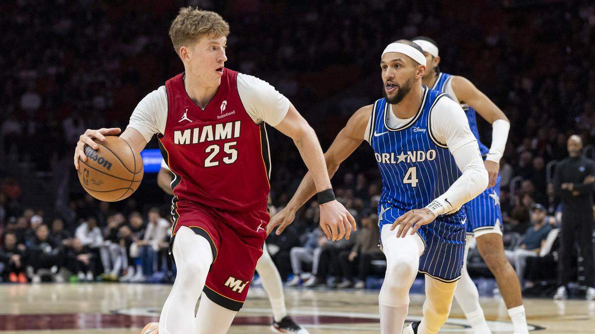 Miami Heat guard Kasparas Jakucionis (25) drives the ball as Orlando Magic guard Jalen Suggs (4) defends in the first half of their NBA game at the Kaseya Center on Wednesday, Jan. 28, 2026, in downtown Miami, Fla.