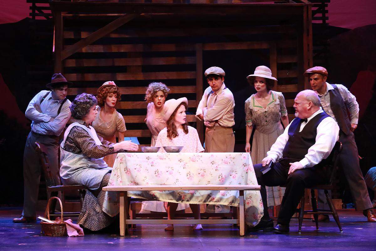 Paulette Oliva, Kimberly Doreen Burns and Peter McClung fight over their family’s future as the ensemble leans in to listen in Actors’ Playhouse’s production of “Bright Star.” (Photo courtesy of Alberto Romeu)