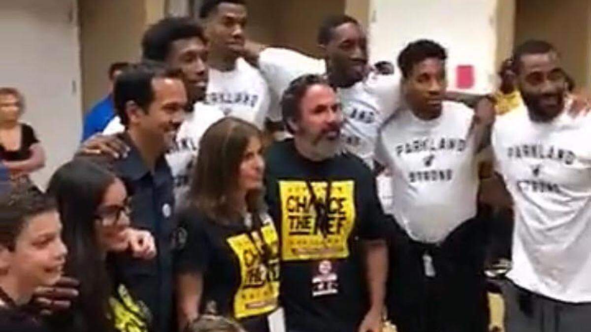 Heat coach Erik Spoelstra and players Josh Richardson, Hassan Whiteside, Bam Adebayo, Rodney McGruder and Wayne Ellington pose for a photo with the parents of Joaquin Oliver Sun., March 18, 2018 during a basketball event at Douglas High in Parkland. 