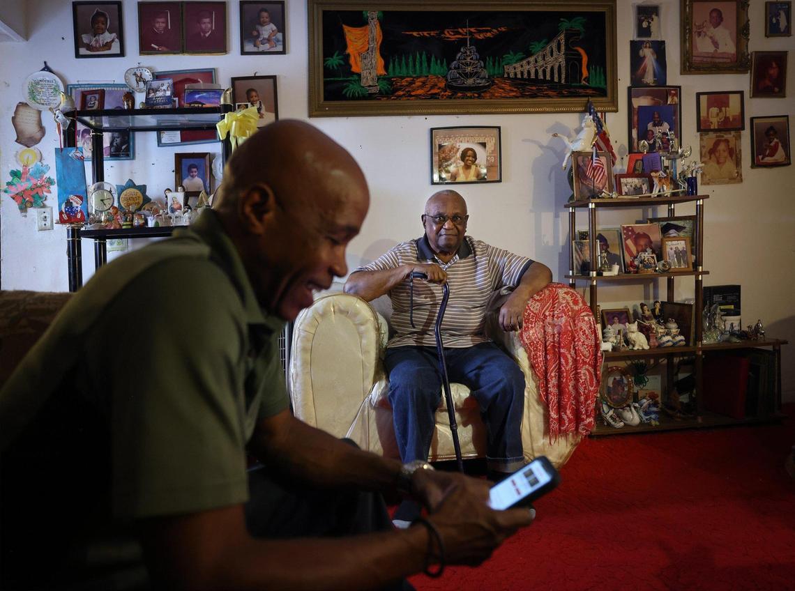 Little Haiti resident Gaspard Paul, 93, right, has owned his home since 1976. his son Cassel Paul, 62, who grew up in the house, says the area has lost a lot of its culture over the years.