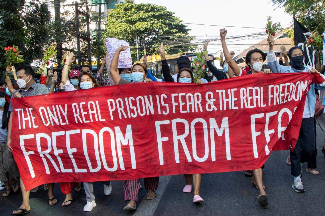 Around 50 anti military protesters holding a large banner with the words “The Only Real Prison is Fear & The Real Freedom is Freedom From Fear” walk down the street to protest against the military coup and demanded the release of Aung San Suu Kyi. Myanmar’s military detained State Counsellor of Myanmar Aung San Suu Kyi on February 01, 2021 and declared a state of emergency while seizing the power in the country for a year after losing the election against the National League for Democracy (NLD). Many protesters were injured after the junta forces opened fire on peaceful protesters using real bullets and an army truck drove into the rally at high speed. Two journalists were also wounded. (Photo by Santosh Krl / SOPA Images/Sipa USA)(Sipa via AP Images)