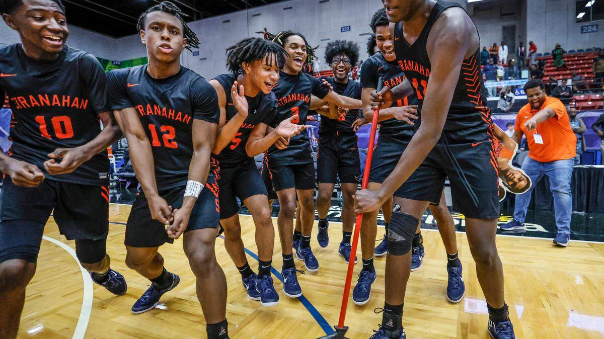 Stranahan High School’s Isaiah Brown (11) sweeps the court as the team celebrates the win over Gibbs High Schoo for the FHSAA Class 4A Boys High School Basketball State Championship