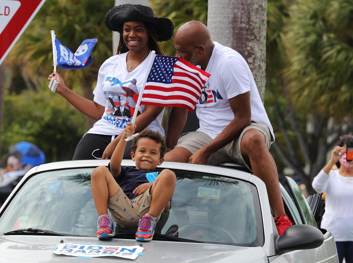 Supporters of VP Joe Biden, Vanessa, Bernard and Ethan gathered in their car during a drive-in car rally held by former President Barack Obama held in North Miami as he campaigns for Joe Biden in South Florida on Saturday, October 24, 2020